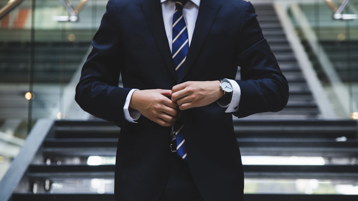 Business professional in a suit standing in a modern office building.